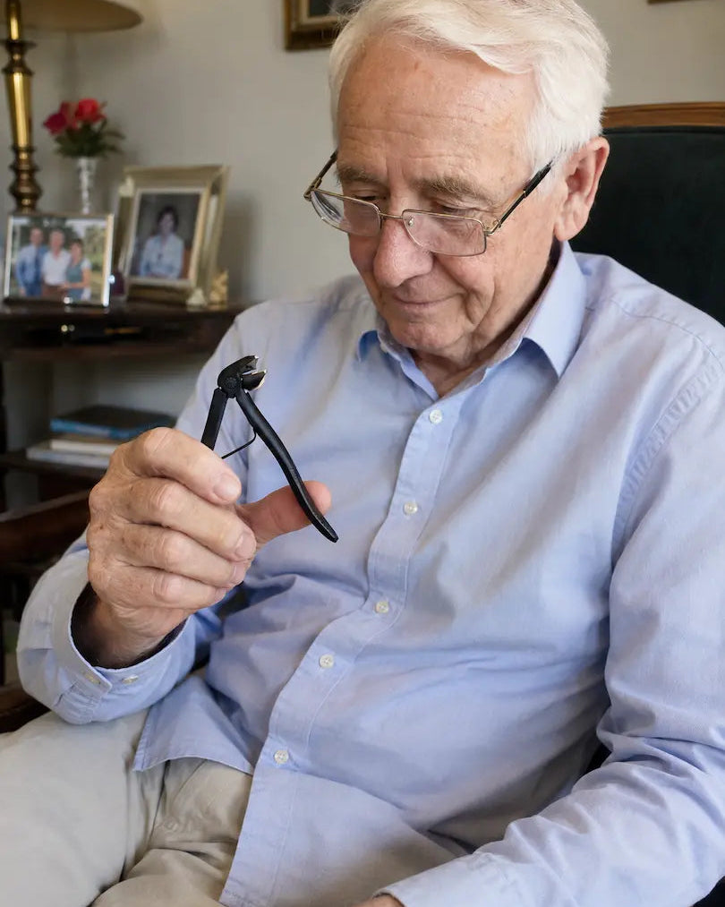 Senior man examining the Relievana Premium Nail Clipper Set before use