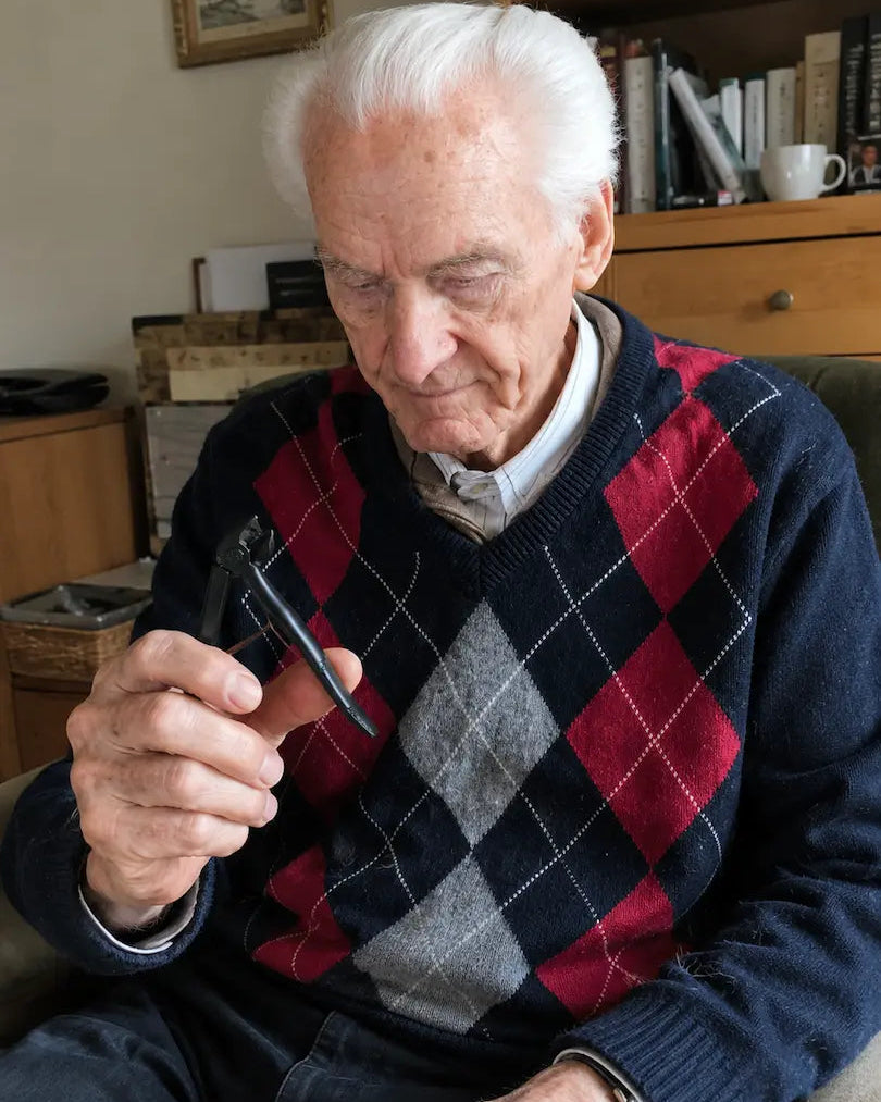 Older man holding the Relievana Premium Nail Clipper Set during his nail care routine