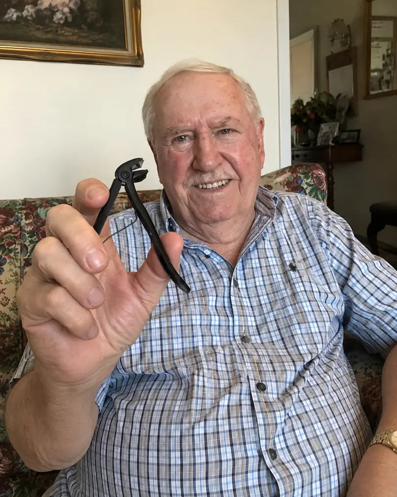 Smiling senior man holding the Relievana Premium Nail Clipper Set at home